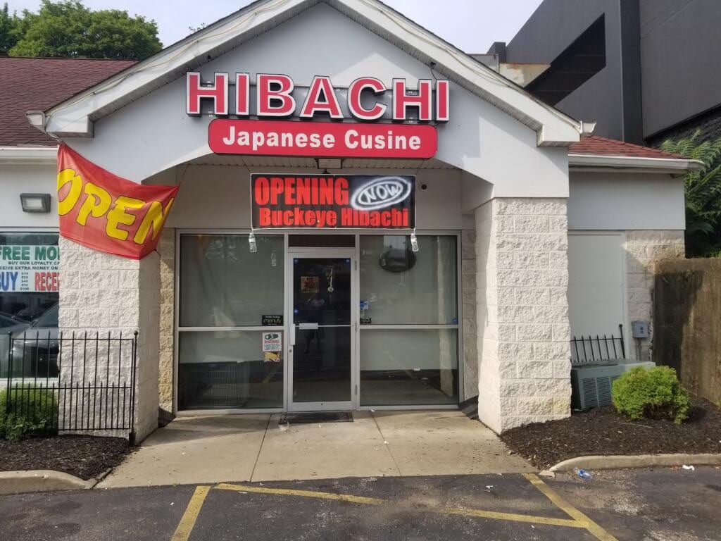 Red HIBACHI Japanese Cusine letters over a storefront with a Buckeye Hibachi opening banner
