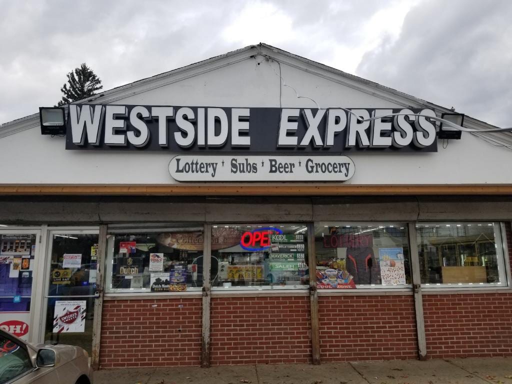 White WESTSIDE EXPRESS channel letters on a raceway above a storefront gable