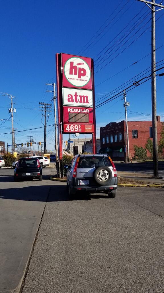 Tall hp Hanini Petroleum pole sign with atm and regular fuel price panels