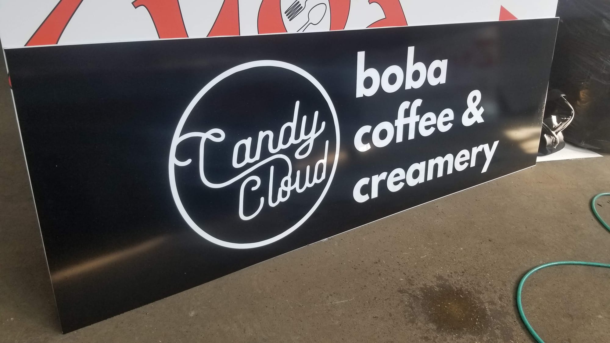 Finished Candy Cloud boba coffee and creamery panel with white graphics on black