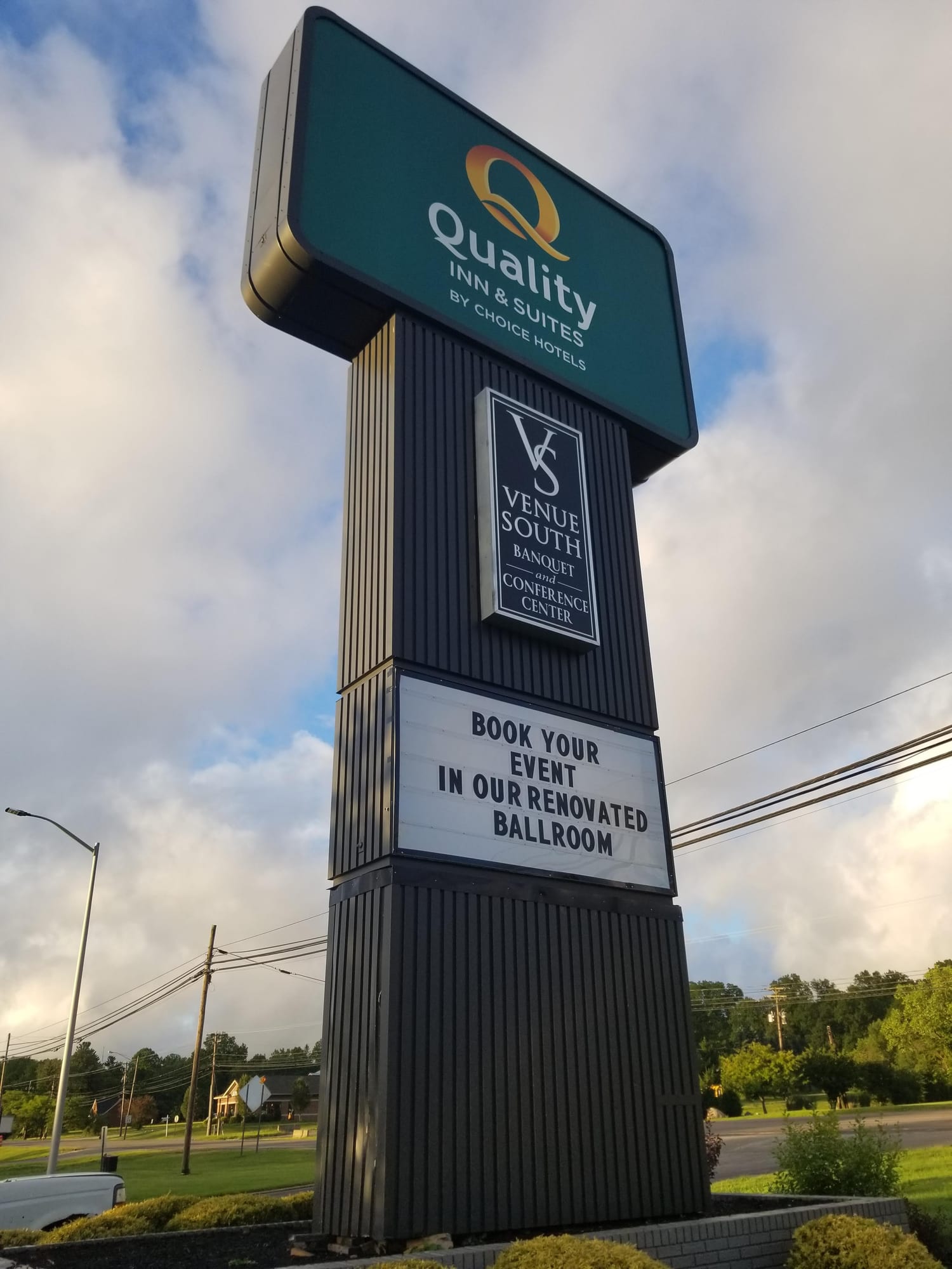 Quality Inn & Suites pylon sign with a Venue South cabinet and a lettered readerboard