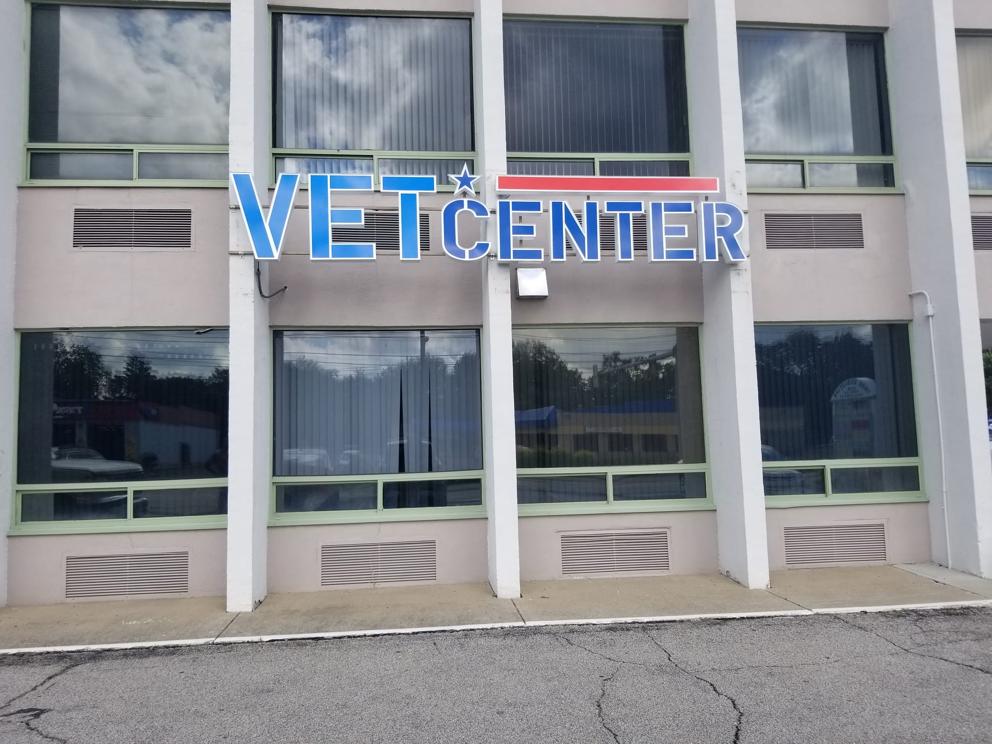 VET CENTER channel letters with a star and red bar mounted on a building facade