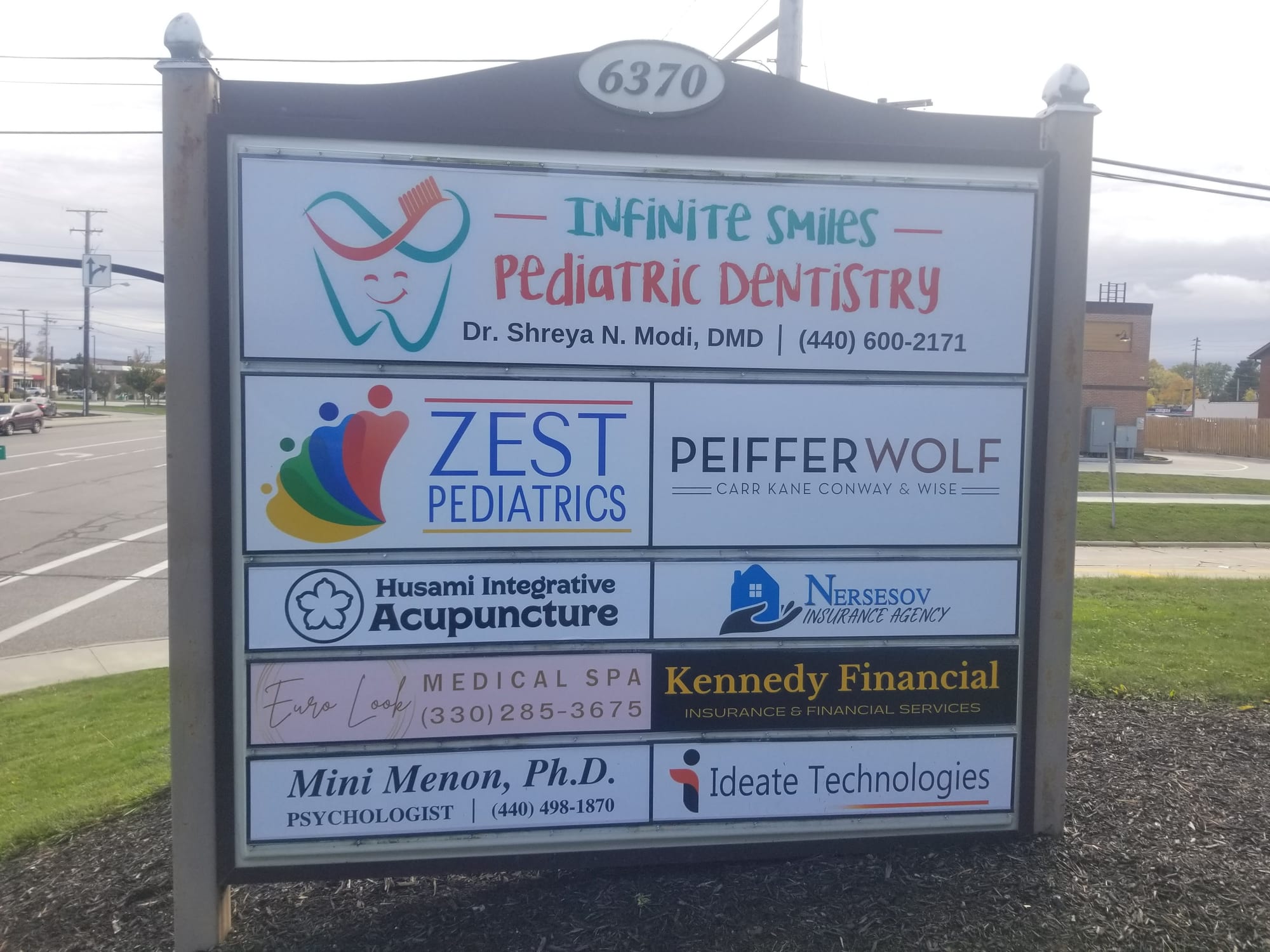 Multi-tenant monument sign listing Infinite Smiles Pediatric Dentistry and other office tenants