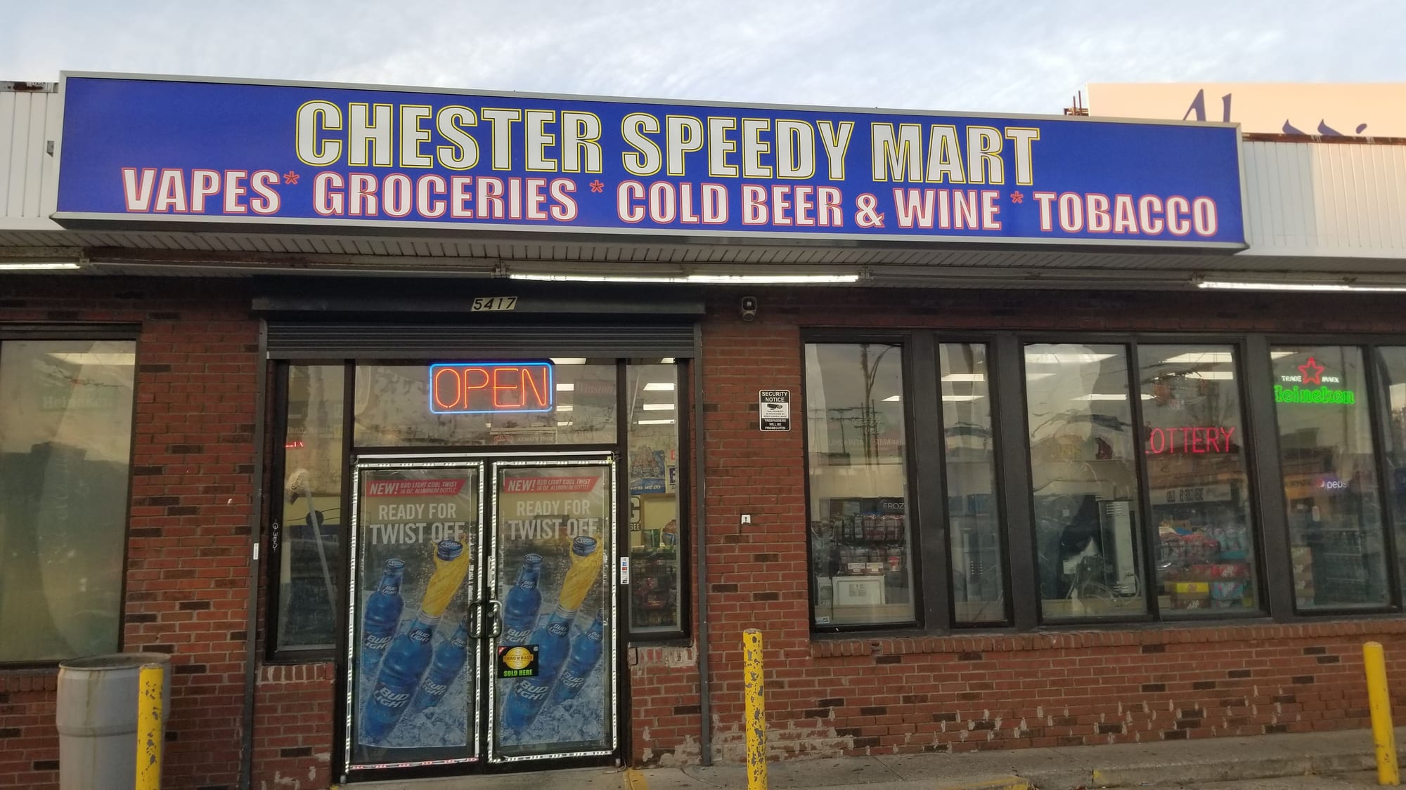 Illuminated CHESTER SPEEDY MART cabinet sign spanning a brick storefront