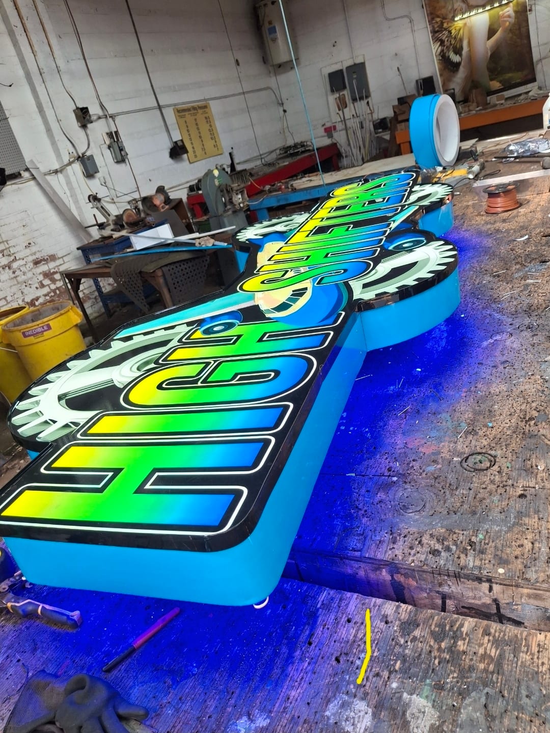 Large High Shifters logo cabinet with blue returns lit on the shop floor