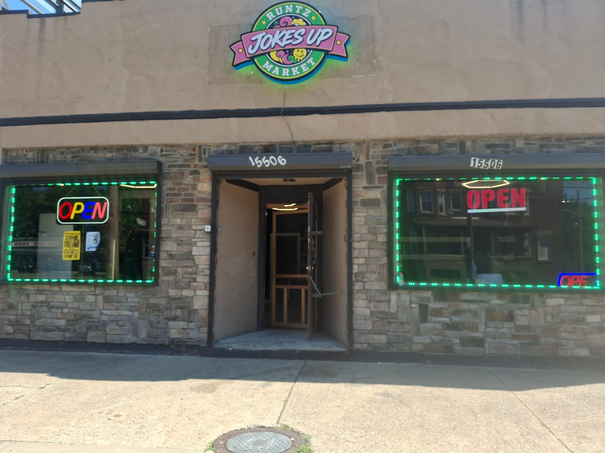Jokes Up Runtz Market logo sign above a storefront with green LED lit windows