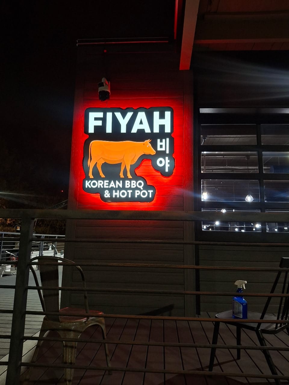 Illuminated FIYAH Korean BBQ & Hot Pot cabinet sign with red halo glow on a wall
