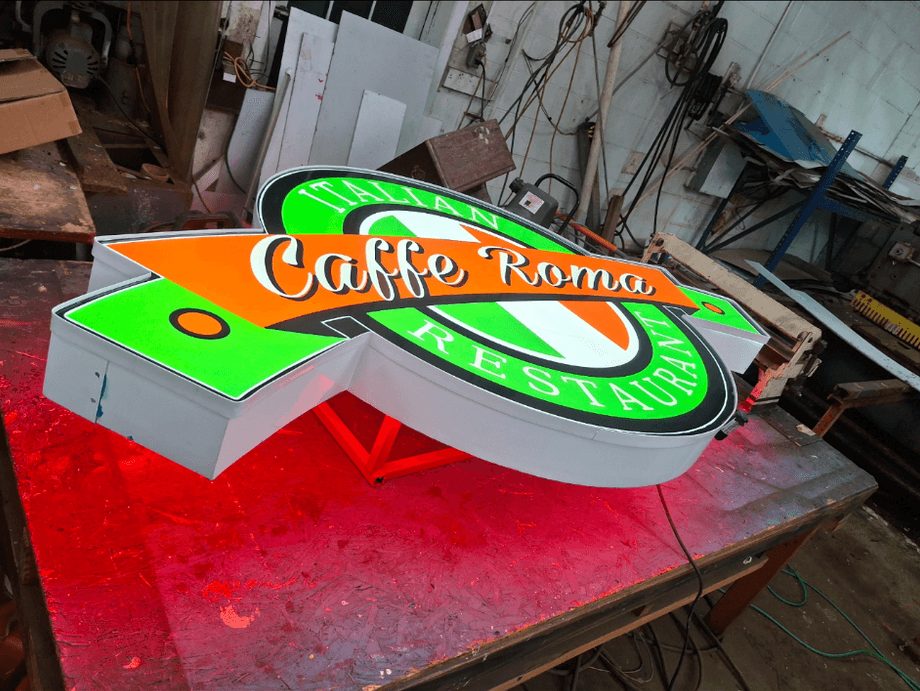 Caffe Roma Italian Restaurant shaped cabinet sign finished on a shop table