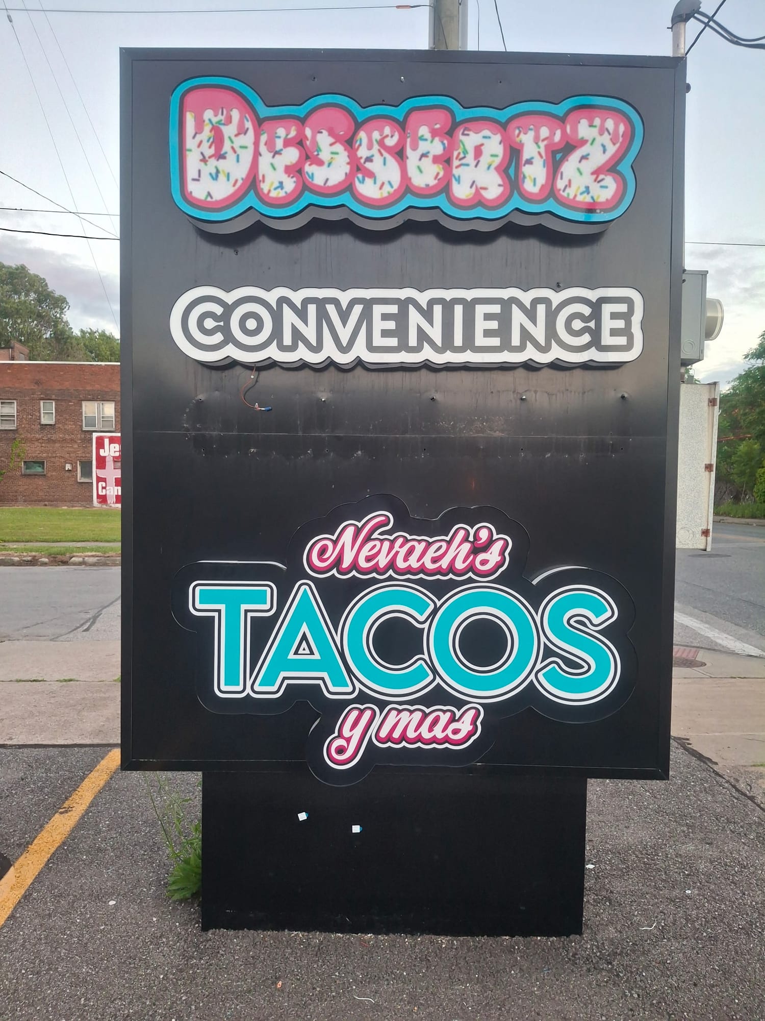 Freestanding sign with DESSERTZ, CONVENIENCE and Nevaeh's Tacos lit letter panels