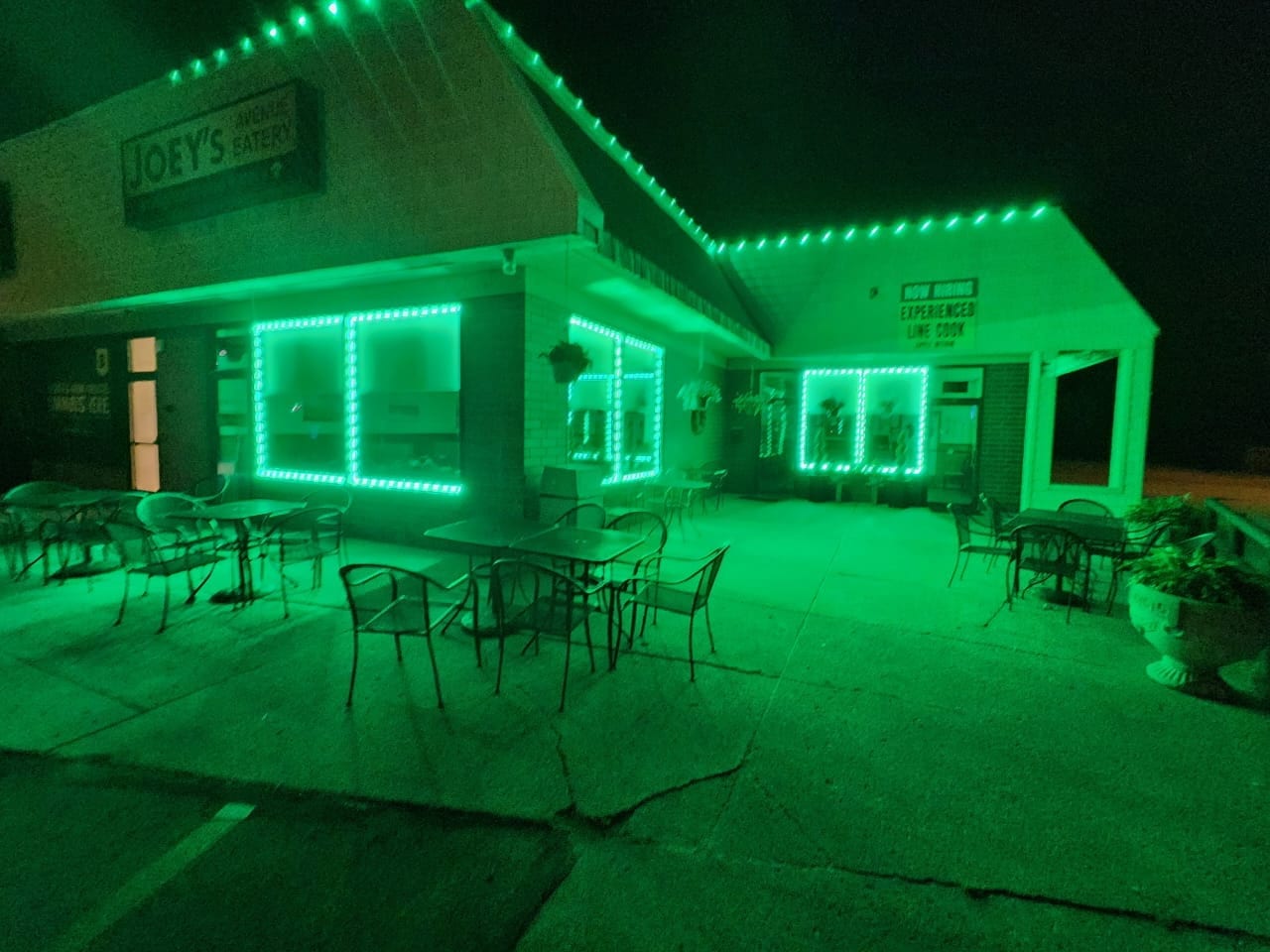 Joey's Avenue Eatery at night with green LED lighting around windows and roofline
